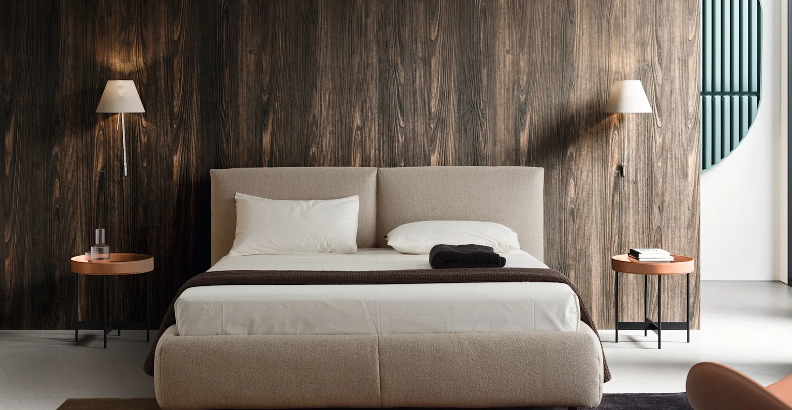 Bedroom with rented upholstered bed, wall lamps and bedside tables